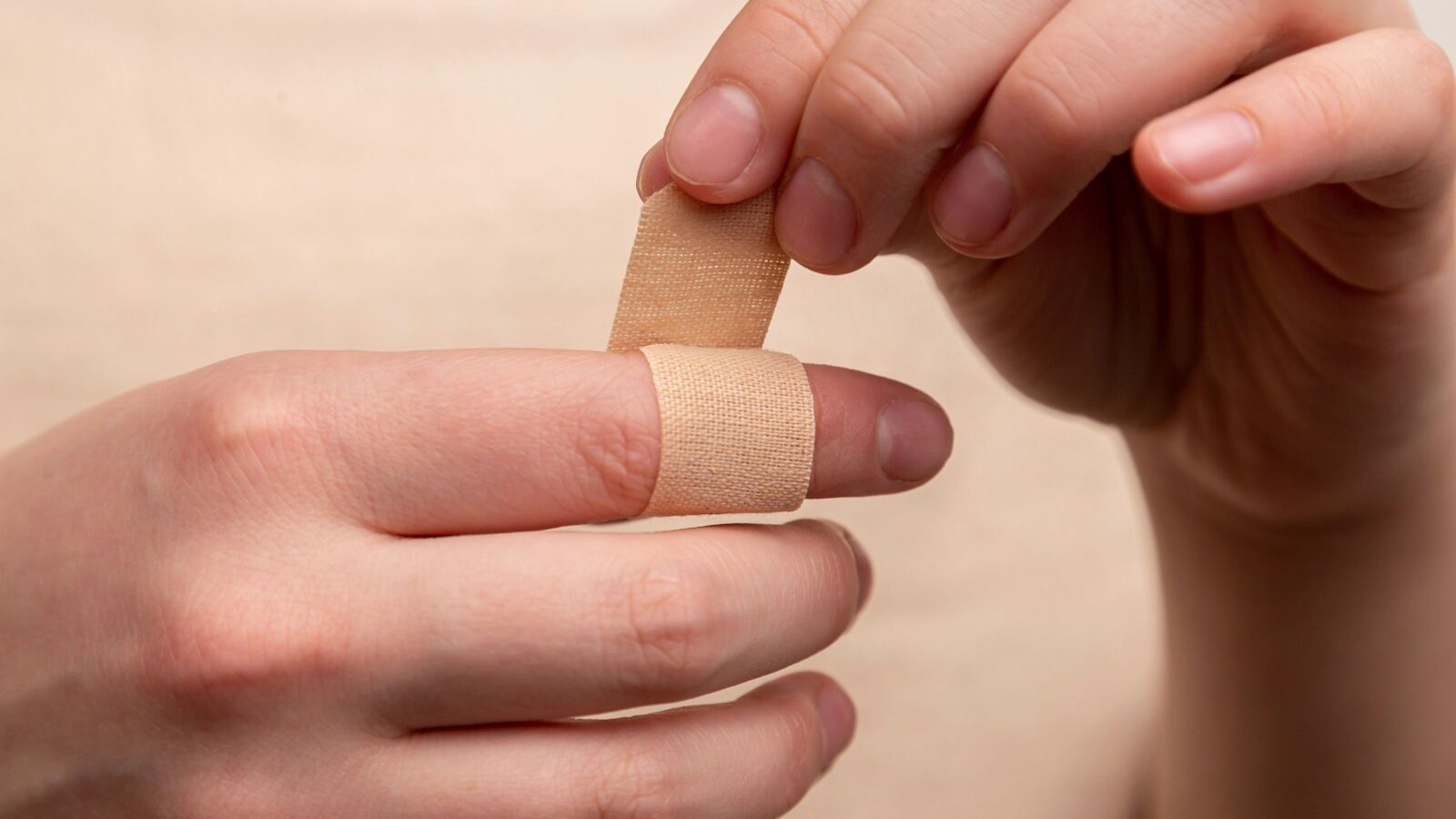 person with band aid on middle finger
